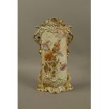 A continental porcelain two handled vase of flattened oval form decorated with flowers and leafage