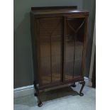 A mahogany and glazed two door display cabinet on cabriole legs