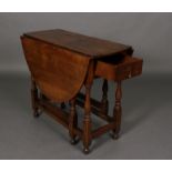 A late 17th century elm gate-leg dining table, the oval top above a frieze fitted single drawer,