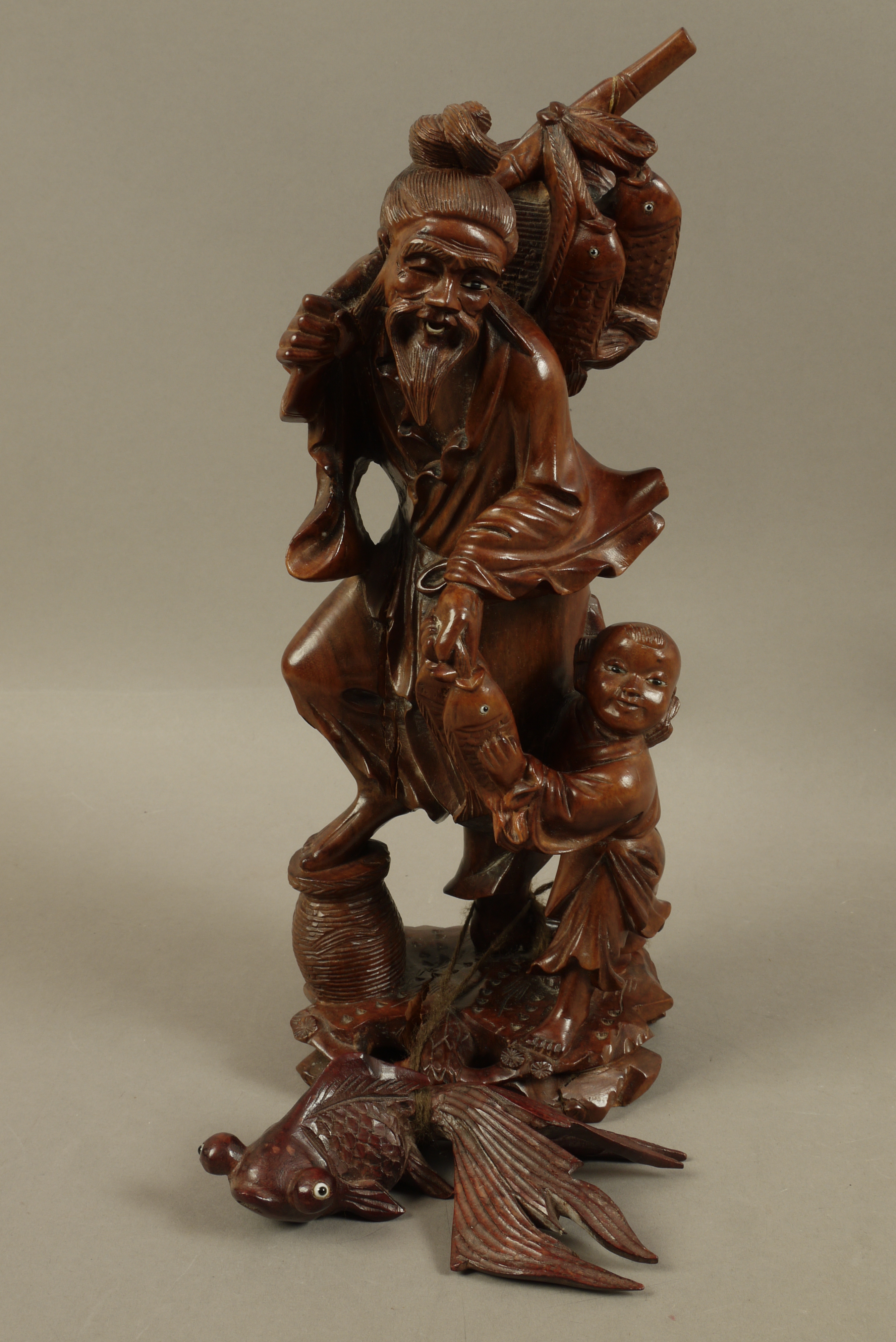 A Chinese hardwood figure of a bearded gentleman and infant holding fish over his shoulder and in - Image 2 of 3