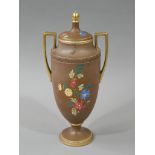 A Carlton ware two handled vase and cover printed in coloured enamels with an flowers on a brown