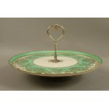 A Noritake cake dish, shaped circular with apple green and ivory rim,