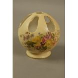 A Royal Worcester globular pot pourri vase decorated with flowers and leafage on a shaded apricot