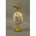 A Royal Worcester ewer the egg shaped body decorated with flowers and leafage on an ivory ground,