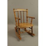 A late 19th/early 20th century faux bamboo doll's rocking chair,