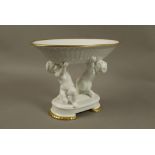 A white porcelain pedestal basket,