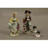 A pair of continental figures of male and female gardeners on floral encrusted bases,