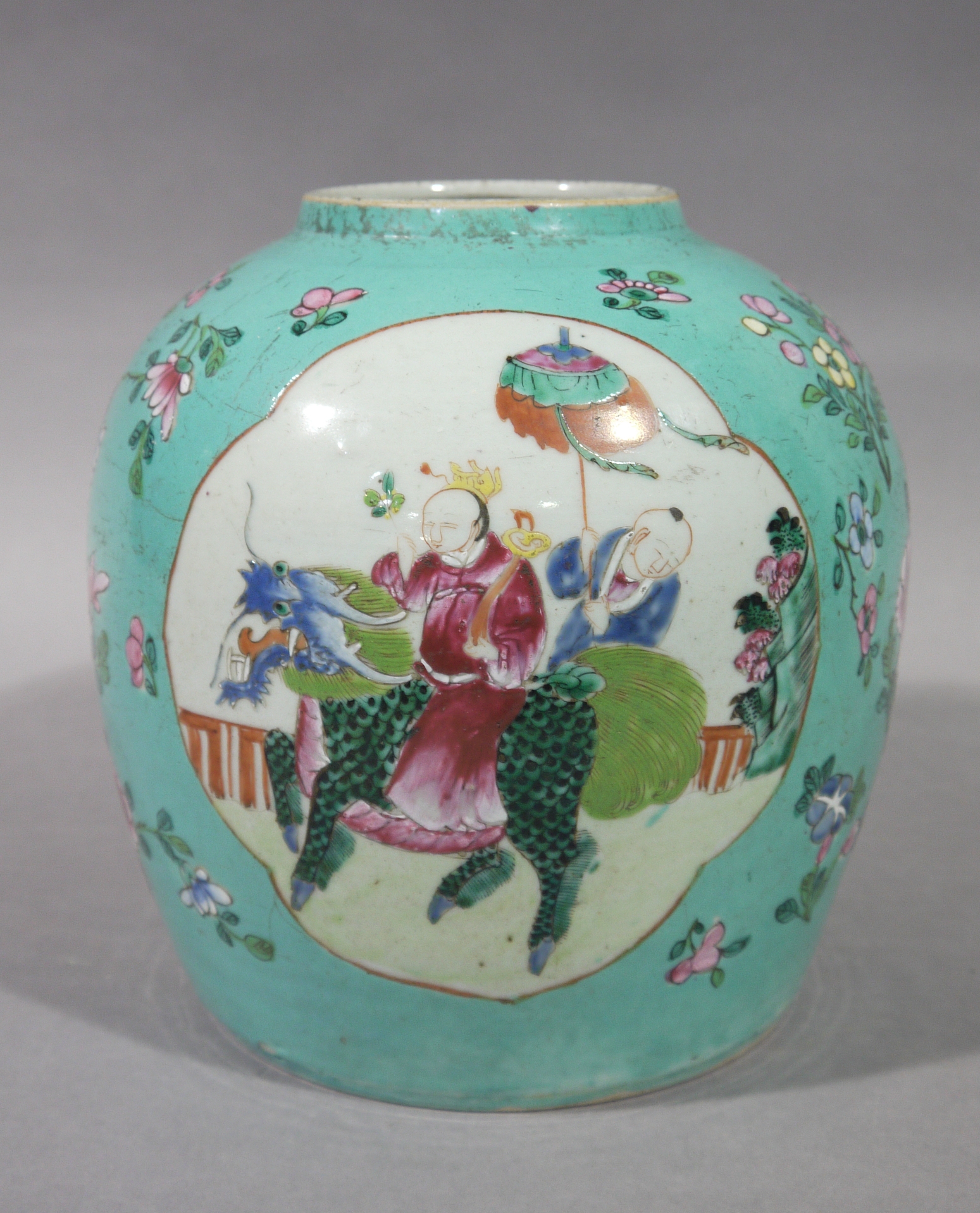 A Chinese famille rose jar decorated with a pair of panels,