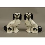 A pair of reproduction pottery Staffordshire spaniels,