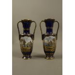 A pair of continental porcelain two handled vases of urnular form with tall cylindrical spreading