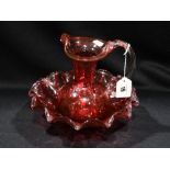 A Cranberry Glass Water Jug And Circular Bowl