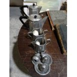 A Four Piece Beaten Pewter Tea Service Together With A Condiment Set