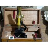 A Cased Students Microscope With Brass Lacquered Finish Barrel