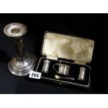 A Boxed Three Piece Silver Condiment Set Together With A Silver Plated Candle Holder