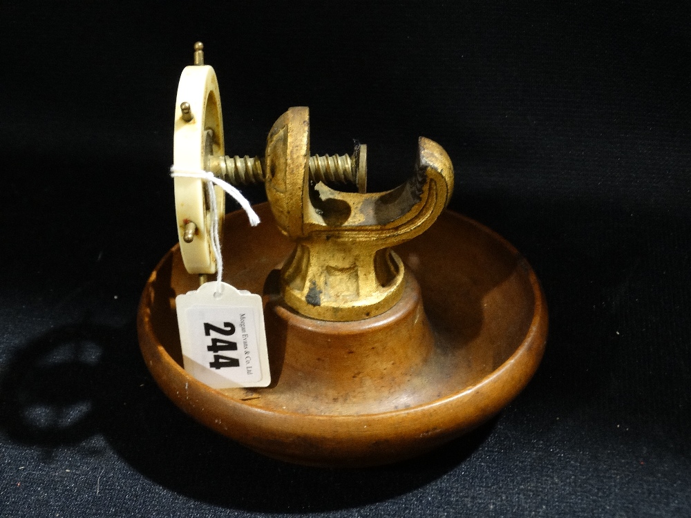 A Brass And Mahogany Nut Cracker In The Form Of A Ships Wheel