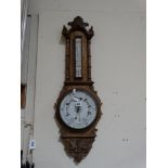 An Oak Encased Wall Barometer With Circular Dial