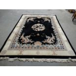 An Excellent Heavy Oriental Black & Cream Ground Carpet With Dragons & A Wave Border Approx 146" X