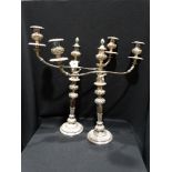 A large size pair of circular based sheffield plated three branch candelabrum of sectional form 25"