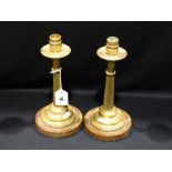 A Pair Of Circular Based Brass Corinthian Column Candlesticks