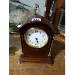A Mahogany Encased Mantle Clock With White Enamel Dial