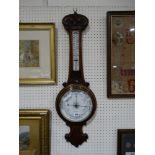 An Oak Encased Wall Barometer With Circular Dial