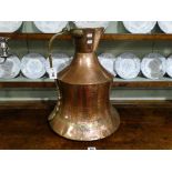 An Antique Copper Wine Jug With Shaped Brass Handle