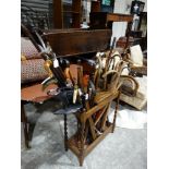 A Polished Oak Stick Stand Containing A Good Quantity Of Mixed Canes & Sticks