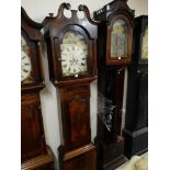 An Antique Mahogany Encased Long Case Clock, The Scrolled Hood Enclosing An Arched Painted Dial With