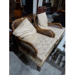 A Pair Of Early 20th Century Walnut Framed Bergere Easy Chairs