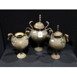 A Set Of Three Indian Brass Circular Based Vases With Cobra Handles