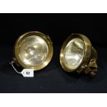 A Pair Of Brass Encased C.A.V. Motorcar Headlights