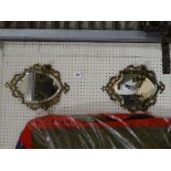 A Pair Of Brass Framed Shield Girandole Wall Mirrors With Double Sconces