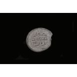 An oval glass seal, with three-line inscription in angular Kufic, possibly to be read as ‘amil |