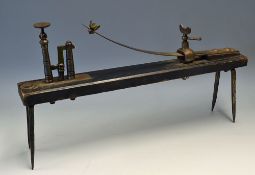 Interesting Knur and Spell Game a horizontal wooden plank with attached iron spikes and a spring