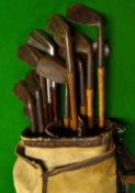 11x various irons and a canvas and leather golf bag - incl 2x early coated steel shafts -