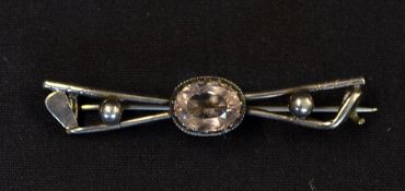 White metal golf brooch - comprising crossed golf clubs, balls and stone brooch (repaired)