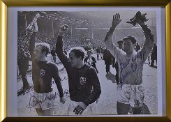 1966 World Cup Signed Photograph signed by England players Banks, Moore, and Cohen, framed