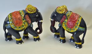 Pair of Wooden Elephants hand coloured in red, blue, yellow and green, measuring 23 x 26cm approx.