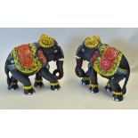 Pair of Wooden Elephants hand coloured in red, blue, yellow and green, measuring 23 x 26cm approx.