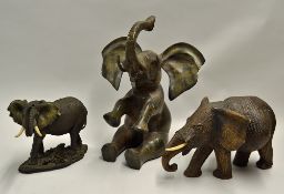 Large Brass 'Sitting' Elephant measures 42cm high, together with a wooden 'pregnant' elephant (