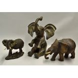 Large Brass 'Sitting' Elephant measures 42cm high, together with a wooden 'pregnant' elephant (