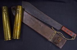 A WWII period British machete with scabbard and a pair of 1942 Royal Artillery shell cases. The