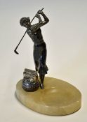 Spelter golfing figure of lady mounted on an oval onyx base ashtray c/w a square mesh golf ball