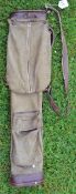 Leather and canvas oval shaped golf bag fitted with folding travel hood/pocket, ball pocket and