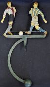 Early Pendulum Metal Football Toy with two players exchange passes as it rocks to and fro on a