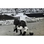 Sir Tom Finney Signed England Football Print a black and white print, depicting Finney evading a