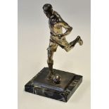 Silvered Spelter Football Figure depicting a footballer striking a ball, on a marble base,