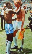 Large poster in colour featuring Bobby Moore and Pele in the famous embrace following the 1970 World