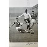 Jimmy Greaves Signed Football Print a black and white print depicting Greaves taking on Leicester'