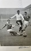 Jimmy Greaves Signed Football Print a black and white print depicting Greaves taking on Leicester'